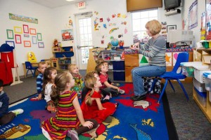 A bunch of preschool kids being read to at a daycare in Columbus Ohio